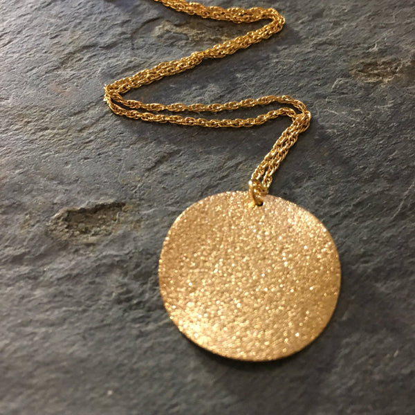round gold pendant